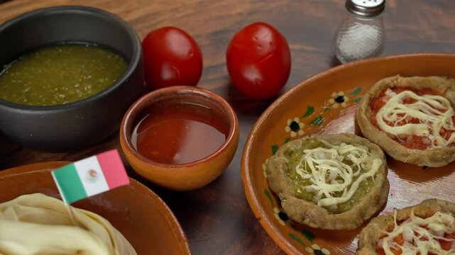 Mexican Pelliscaditas, sopes and quesillo cheese with a mexican flag, Pan right