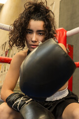 Smiling Mexican boxer in the gym practicing martial arts.