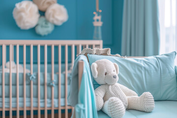 white crib with a blue canopy and a teddy bear on the floor. The room is decorated in blue and white colors