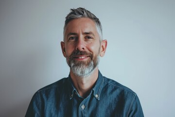 Portrait of a handsome mature man with grey beard and mustache.