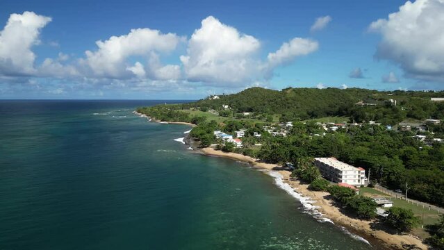 Flying along the coastline of the beautiful oceanfront town of Rincon, Puerto Rico in the Caribbean