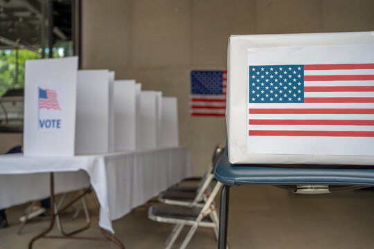 united states of america presidential election polling place, vote center, poll box and voting booth, us flag on the wall