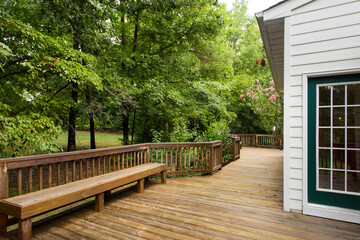 Wooden Deck With Built-In Bench Overlooking Lush Green Forest