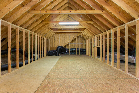 Unfinished Attic Space With Wooden Beams And Visible Insulation