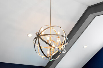 Modern Chandelier With An Abstract Design And Glowing Bulbs In Cathedral Ceiling