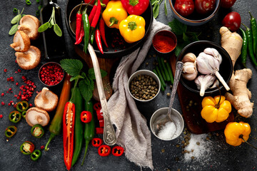 Spices , peppers, garlik, tomatos, mushrooms on dark background. Ingredient for cooking