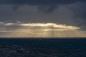 Kapa'a Beach Park, East Side ( Coconut Coast ), Kauai, Hawaii. Sunlight shining through clouds, giving rise to crepuscular rays