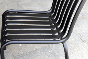 A lounge chair stands on the sidewalk on a street in a big city.