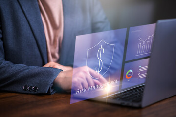 Risk management concept , businessman using laptop to anlayzt data surrounded by risk mask icon..