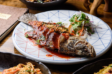a plate with grilled chilli sea bass
