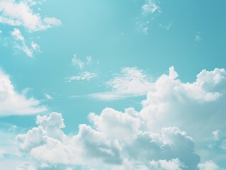Light blue sky with soft white clouds, creating a serene and open background