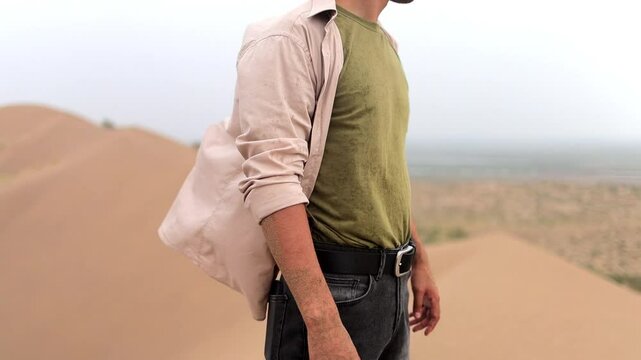 Man walking, climbing the barchan in the desert, Singing barchans, Kazakhstan, Altyn Emel, desert, steppe, sand | Человек идёт, поднимается на бархан в пустыне, Поющие барханы, Казахстан, Алтын Эмель,