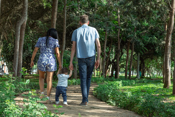 Siblings mother father grand parent Family members holding hands while walking in a park during a sunny day in Lima Peru