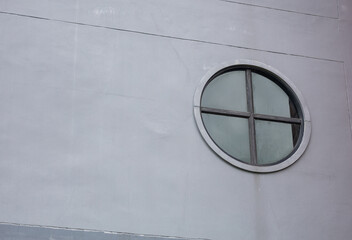 round glass window gray building wall