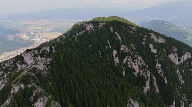 Drone moves slowly right to left, showcasing Zarnesti city and Piatra Mica peak