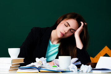 Bored Student sleeping during a lecture in a classroom. Portrait of bored school girl lying and sleeping at desk during lesson. Bored Education concept. Bored Lesson and homework in university.