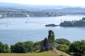 Fototapeta premium Mount Edgcumbe Country Park Folly an artificial ruin built from stone from the churches of St George and St Lawrence Stonehouse. with Drake's Island and Plymouth Sound in the background England
