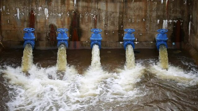 Water outlet from dam wall. Howell Bunker valve in operation, Pressurized water outlet from dam wall, water from a pipeline, Water flowing out of pipe from factory industrial