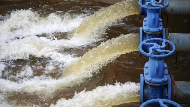 Water outlet from dam wall. Howell Bunker valve in operation, Pressurized water outlet from dam wall, water from a pipeline, Water flowing out of pipe from factory industrial