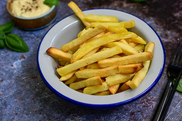  Home made   Fresh fried French fries  in a bowl on wooden rustic  background