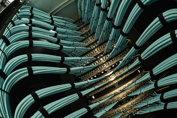 close up of network cables connected to server racks in data center room.