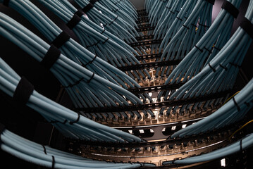close up of network cables connected to server racks in data center room.