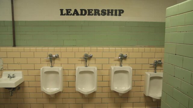 High school Male bathroom with urinals and leadership sign