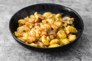turmeric gnocchi with pumpkin and onion in creamy sauce, healthy plant-based food