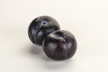Two ripe sweet black plums