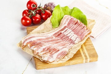 Sliced pork bacon oved board
