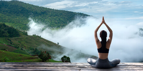 Young woman practicing yoga in the nature