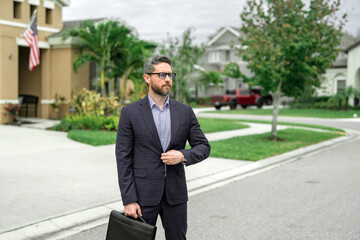 Business man walk near house in american neighborhood. Business man walk down street, late for a meeting. Business man in suit walking be success. Walking business man.