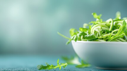 Fresh green arugula leaves in a white bowl over a blurred background. Healthy salad ingredient full of vitamins. Concept of a fresh diet.