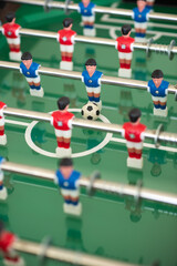 Football table soccer game, red and blue team. Indoor sport game for social relaxing. closeup for details.
