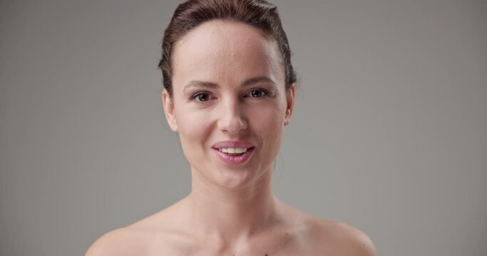 Beauty, health, cosmetics, anti-aging therapy and skin care concept - young beautiful brunette Caucasian woman nodding her head showing yes agreement gesture