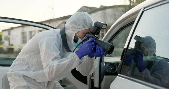 Forensic photographer, vehicle and inspection in street for crime, hijacking and evidence for police. Man, camera and outdoor on road with investigation, accident and ppe suit by stolen car in Sydney