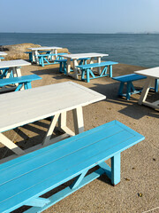 Wooden chairs on the seashore