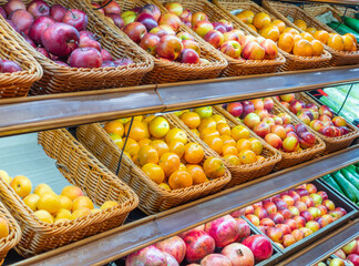 Assortment of fresh fruits and vegetables on store shelves, on market counter. A large selection of fresh fruits and vegetables on the market.