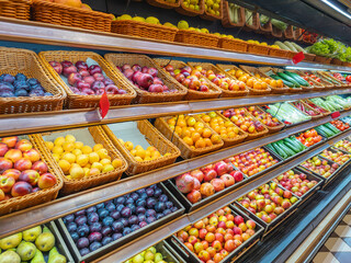 Assortment of fresh fruits and vegetables on store shelves, on market counter. A large selection of fresh fruits and vegetables on the market.