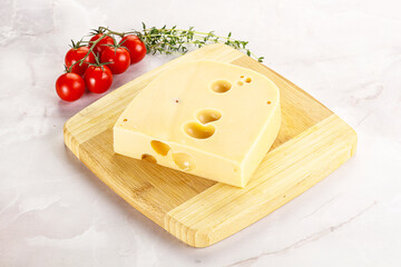 Maasdam cheese brick over board