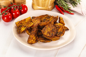 Golden baked potato Idaho with spices