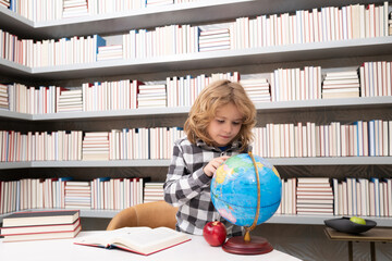 School and students in classroom. Education kids. Clever Child pupil student in the school class. Studying and learning concept. School boy in library near school supplies. Kid learn geography with