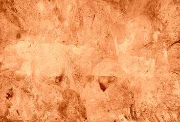 Abstract marble texture background. Different shades of peach fuzz color. Sometimes lighter, sometimes darker tones. Chaotic spots. Brown colors.