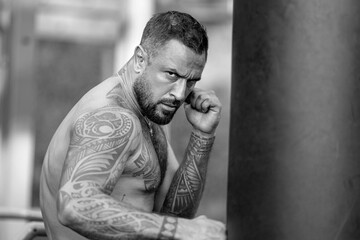 Hispanic male sport model boxing punching bag. Man boxer face close up. Knockout. Fists fight. Sport Man ready for boxings challenge. Mans fight. Boxings fight. Boxing sport.