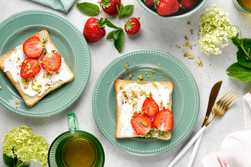 Sweet Toast with strawberry, cottage cheese and pistachios . Sandwich, Bruschetta, snack, appetizers with strawberry. top view