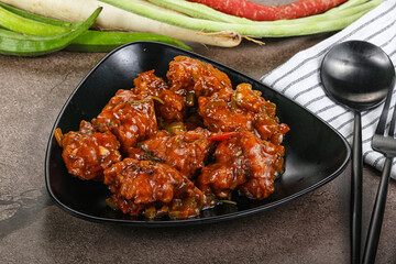 Manchurian chicken with sauce and spices