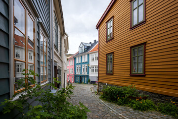 Fototapeta premium Charming alleyway with cobblestone path in old town in Bergen, Norway