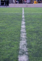 White and Yellow lines on a sports field. With artificial grass, this will utilize for many kinds of sports in school; football, rugby, softball.