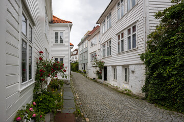 Charming narrow street with cobblestones in historic area in Bergen, Norway