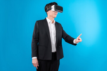Asian businessman looking thorough VR while touching screen with connecting business world report...